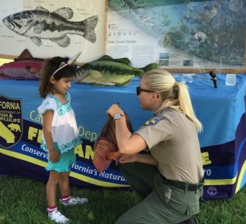 Julia gives a lesson on fish anatomy at a Fishing in the City event