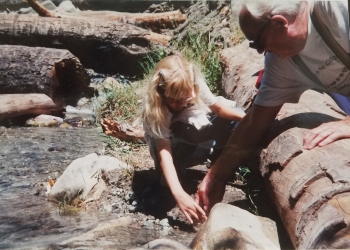 Julia releasing her trout with the help of a volunteer in 1999