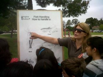 Hillary giving a presentation on fish handling at a Fishing in the City event.