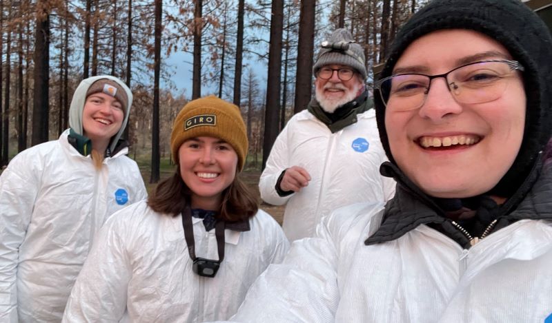 four scientists posing for a selfie in protective suits during an outing to conduct bat surveillance