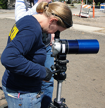 scientist looking through scope