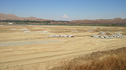 Barren earth with large piles of large rocks distributed throughout