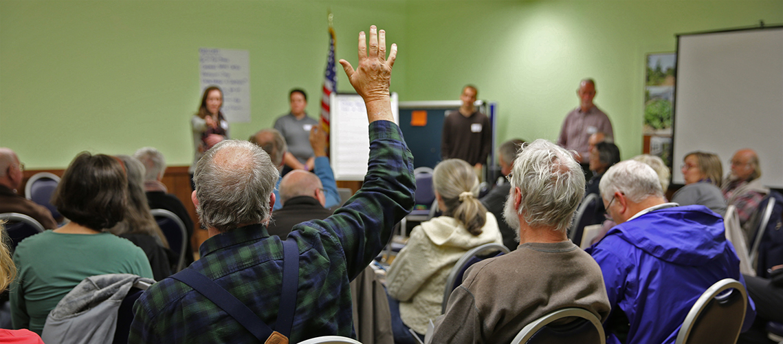 Community members raising hand