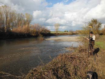A biologist conducts an RTK survey on Butte Creek.