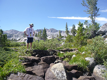 CDFW volunteer inspects the percolation dam which was installed to block invasive trout from accessing restored Sierra Nevada yellow-legged frog habitat