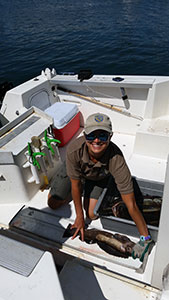 Ali Kearney samples a lingcod in Santa Cruz Harbor. Photo credit: J. Schaaf-DaSilva